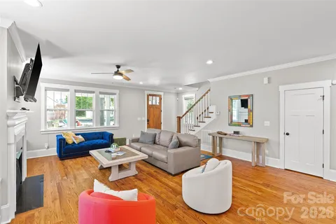 a living room with fireplace furniture and a flat screen tv