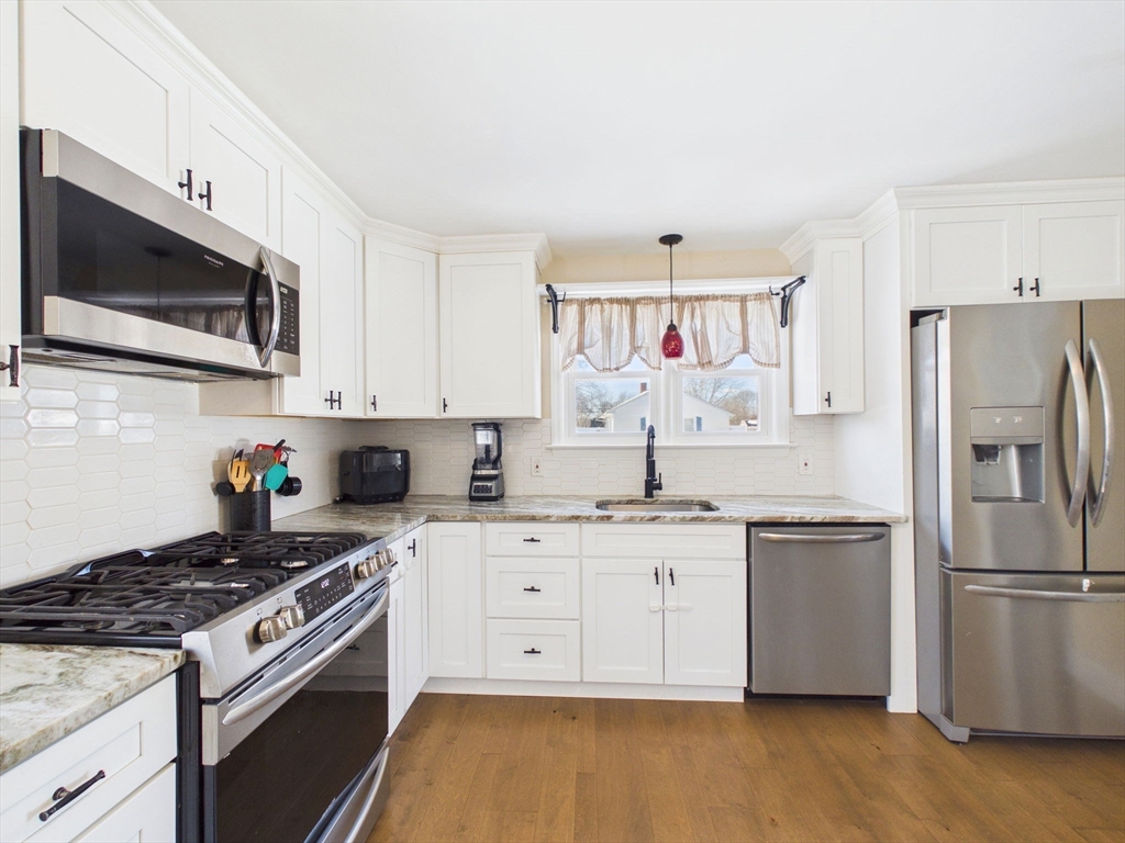 112 Lawson Avenue Acushnet, MA 02743 - Photo 16 of 28 a kitchen with stainless steel appliances granite countertop a stove a sink and a refrigerator
