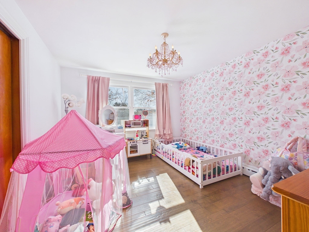 112 Lawson Avenue Acushnet, MA 02743 - Photo 23 of 28 a bedroom with a bed and a chandelier