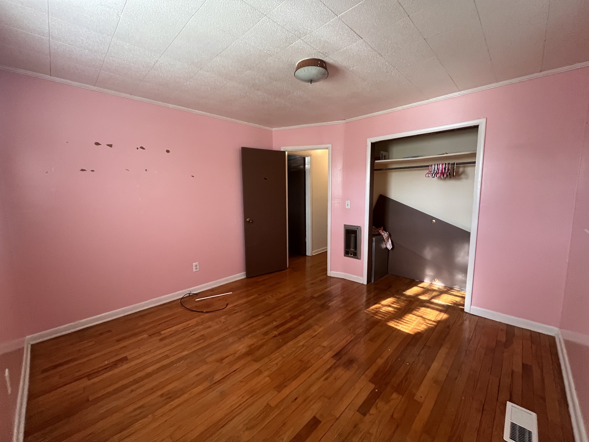 1035 North 3rd Street Pulaski, TN 38478 - Photo 9 of 17 a view of an empty room with wooden floor and a window
