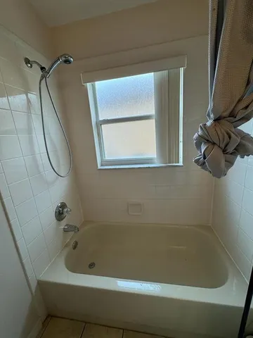 a bedroom with two beds next to a window