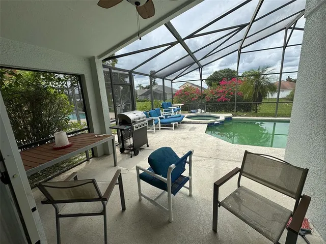 a sitting area with glass top table and chairs