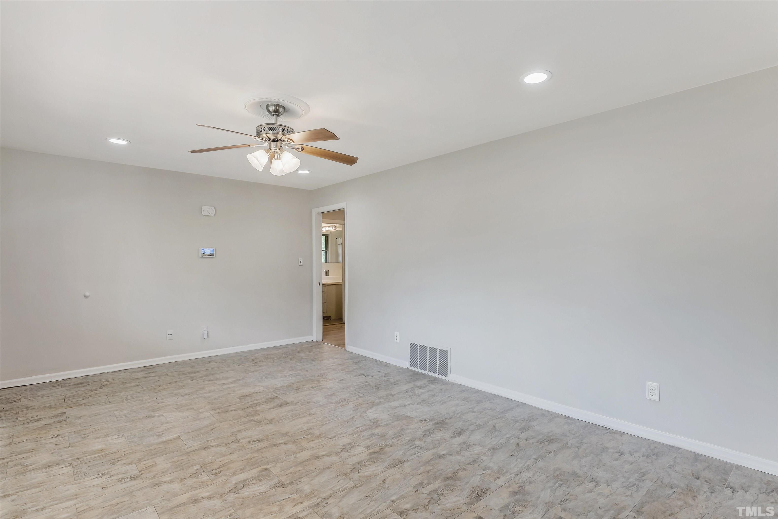 425 Jones Franklin Road Raleigh, NC 27606 - Photo 5 of 27 a view of an empty room with a ceiling fan
