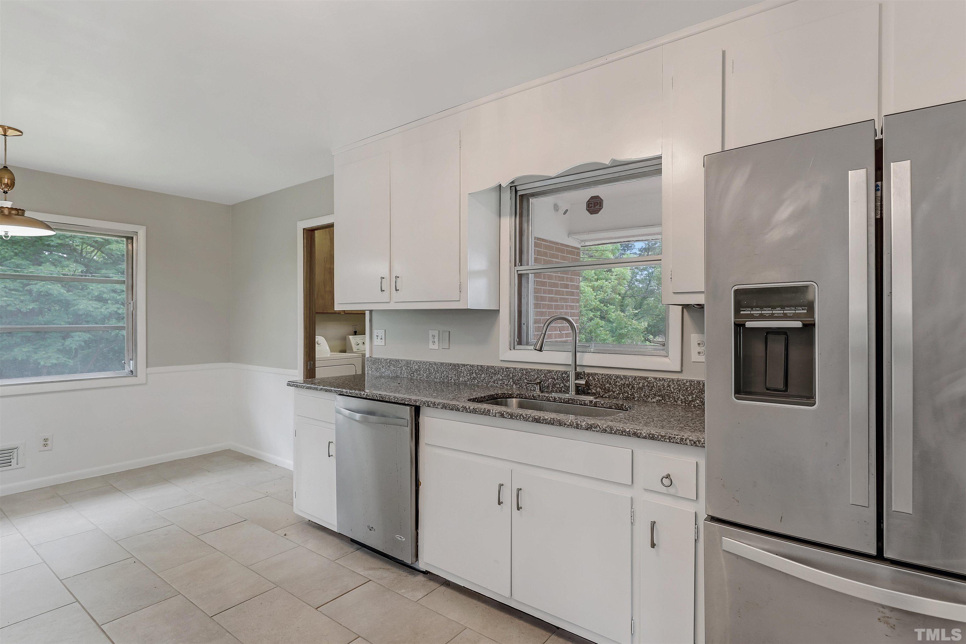 425 Jones Franklin Road Raleigh, NC 27606 - Photo 8 of 27 a kitchen with a refrigerator and a sink