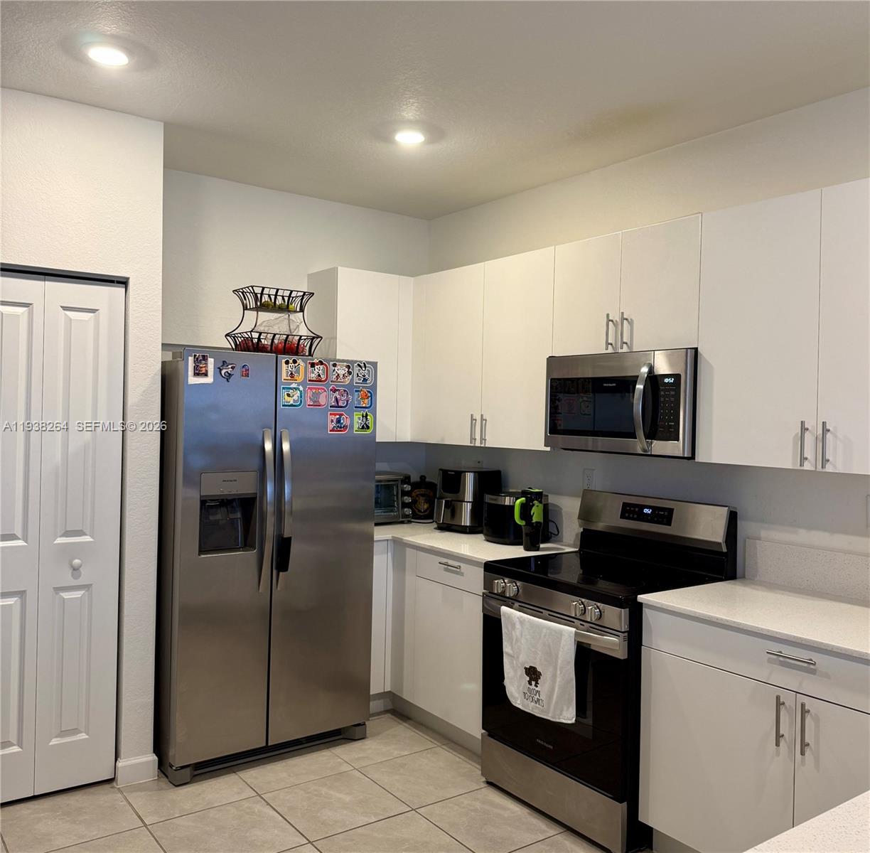 23049 Southwest 129th Place Miami, FL 33177 - Photo 9 of 29 a kitchen with stainless steel appliances granite countertop a refrigerator a stove and a sink