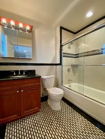 a bathroom with a toilet a sink and shower