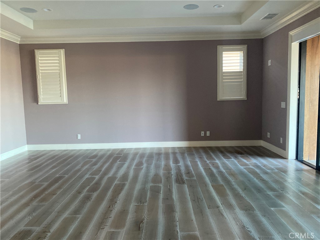 107 Iron Gate Irvine, CA 92618 - Photo 20 of 37 a view of an empty room with wooden floor and a window