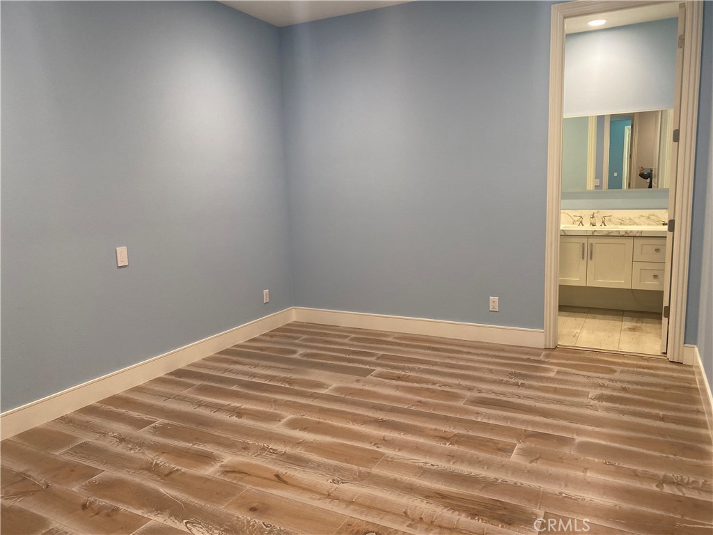 107 Iron Gate Irvine, CA 92618 - Photo 23 of 37 a view of empty room with wooden floor