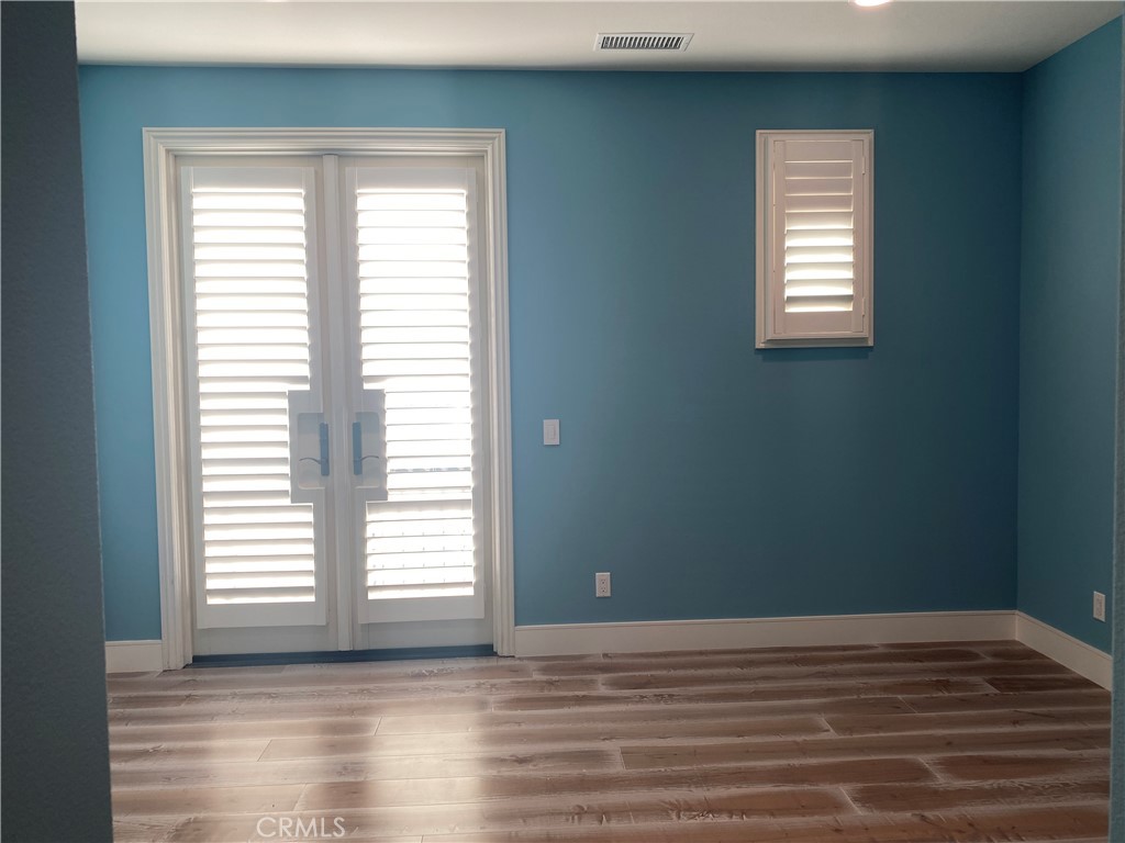107 Iron Gate Irvine, CA 92618 - Photo 25 of 37 a view of a room with wooden floor and windows