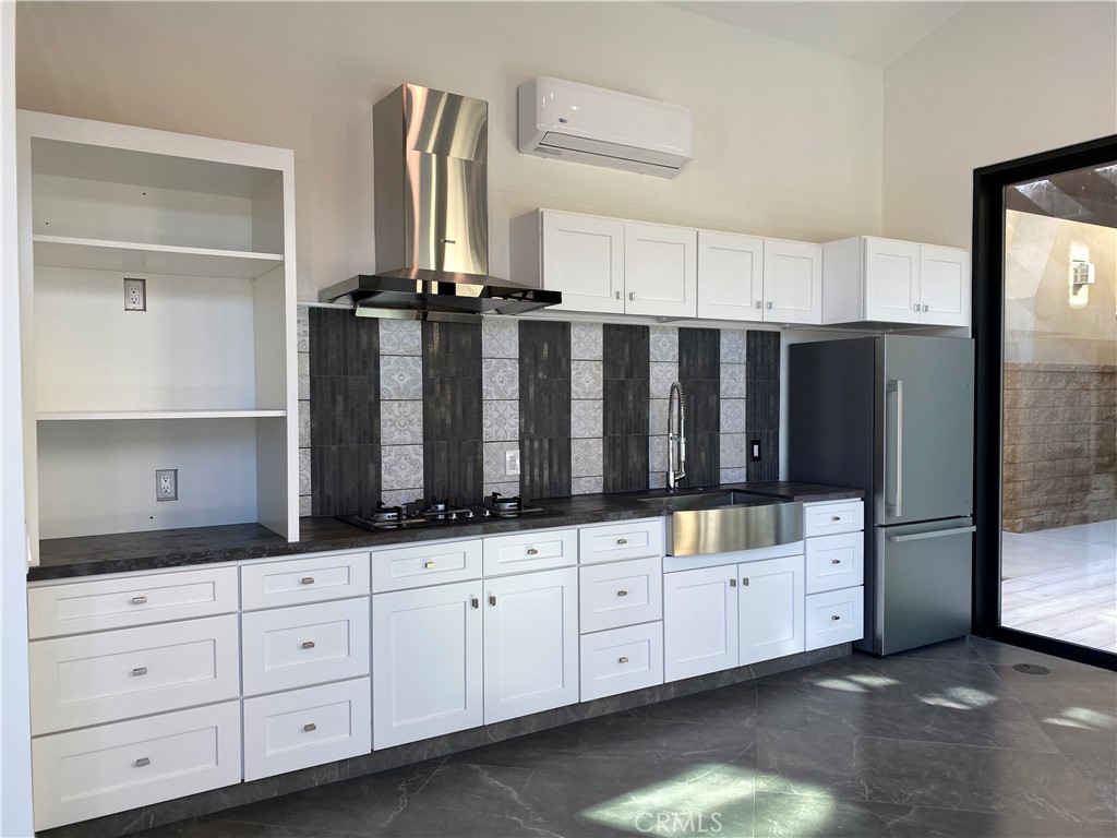 107 Iron Gate Irvine, CA 92618 - Photo 35 of 37 a kitchen with white cabinets and sink