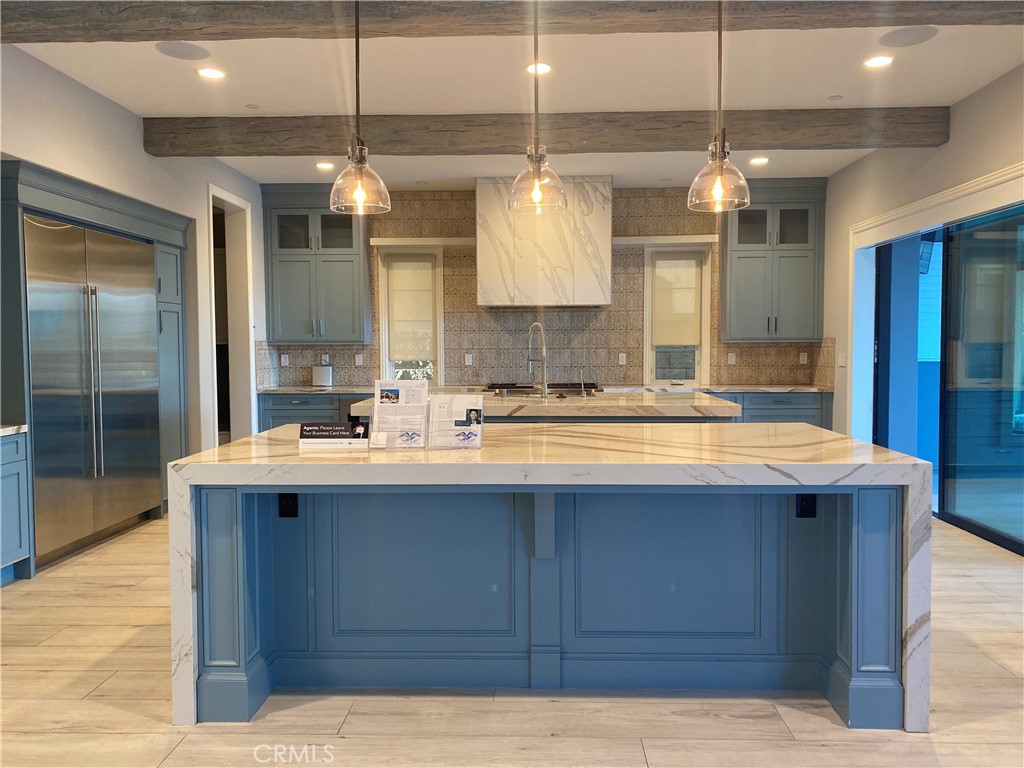 107 Iron Gate Irvine, CA 92618 - Photo 7 of 37 a kitchen with a sink and chandelier