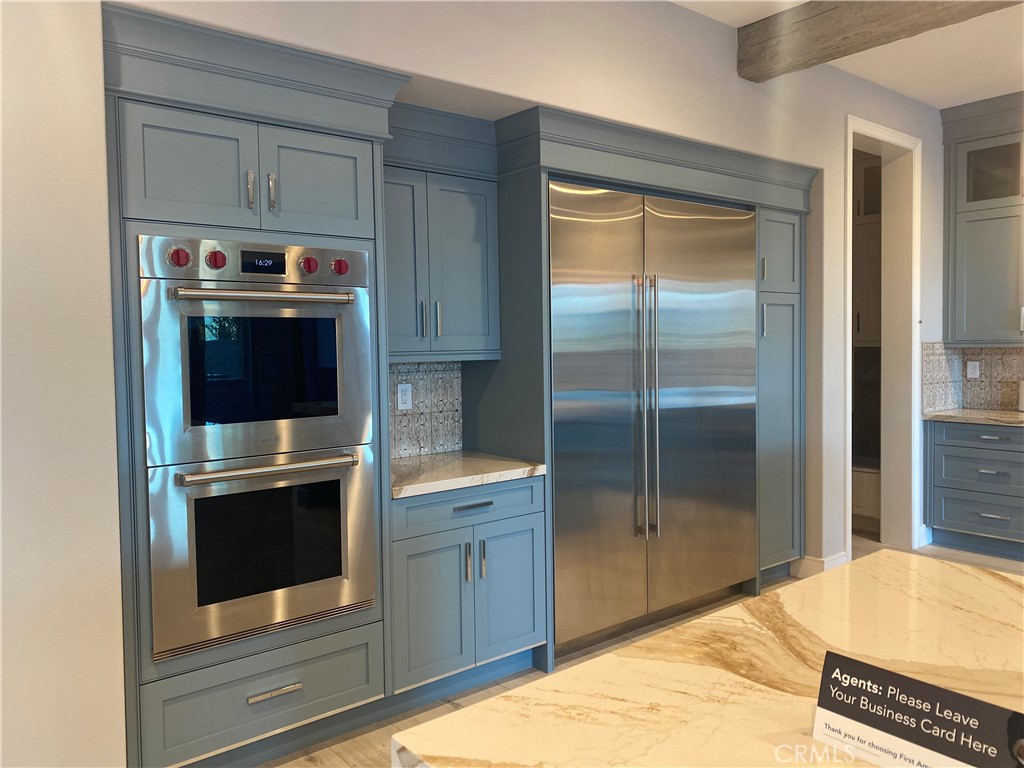 107 Iron Gate Irvine, CA 92618 - Photo 8 of 37 a kitchen with stainless steel appliances granite countertop a stove and a refrigerator