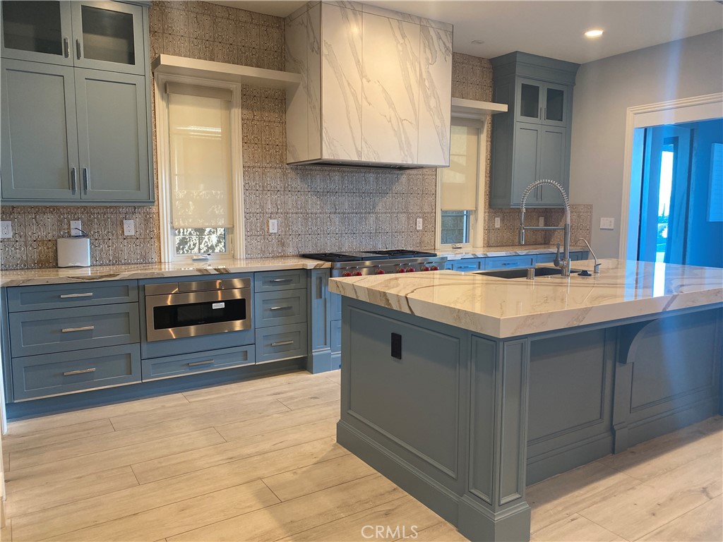 107 Iron Gate Irvine, CA 92618 - Photo 9 of 37 a kitchen with stainless steel appliances granite countertop a sink stove and cabinets