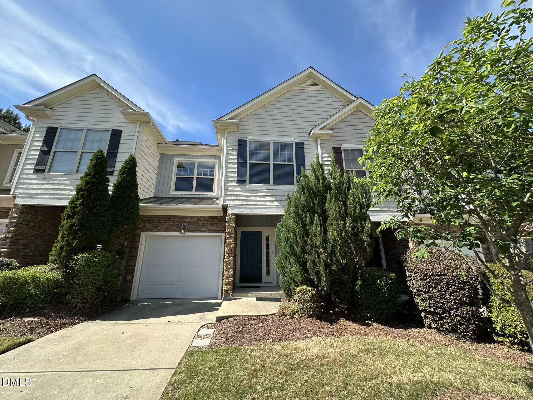 1056 Indigo Ridge Place Cary, NC 27519 - Photo 2 of 33 a front view of a house with a yard and garage