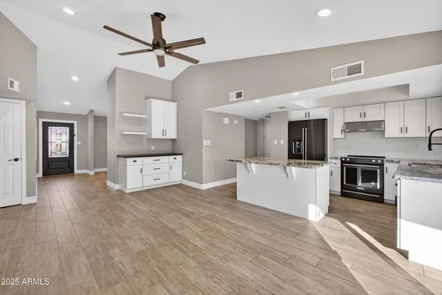 a view of kitchen with sink microwave and stove top oven