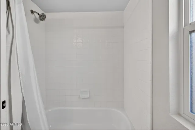 a close up of a bathtub with a shower