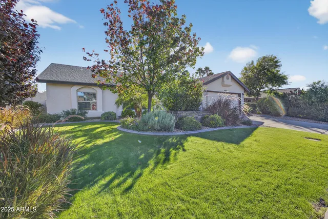 a view of a house with pool and a yard