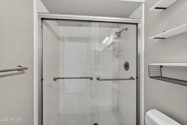 a bathroom with a glass shower door