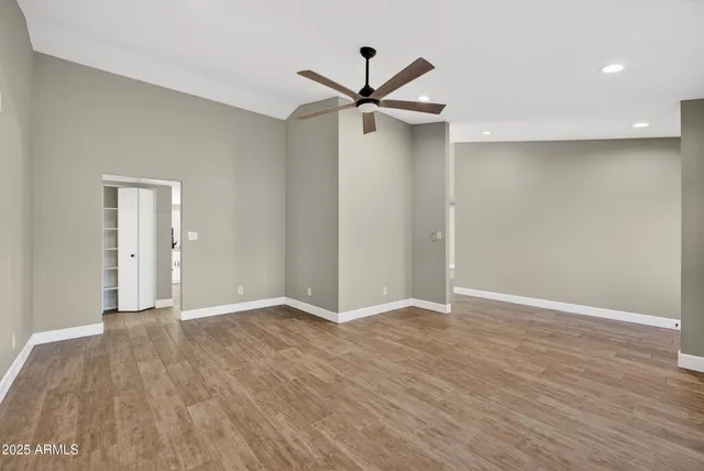a view of an empty room with wooden floor