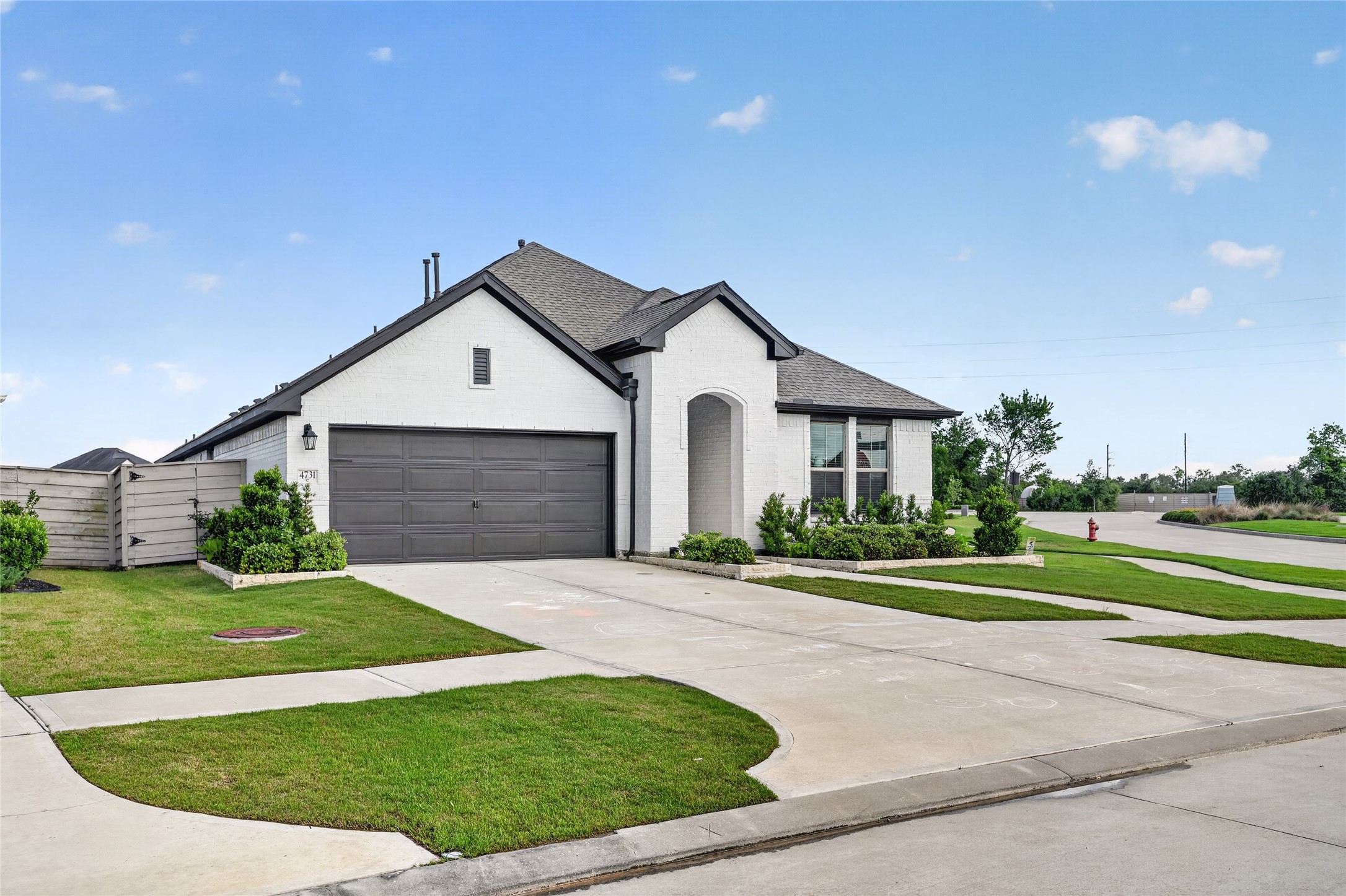 4731 Cedar Butte Lane Manvel, TX 77578 - Photo 2 of 42 a front view of a house with a yard and garage