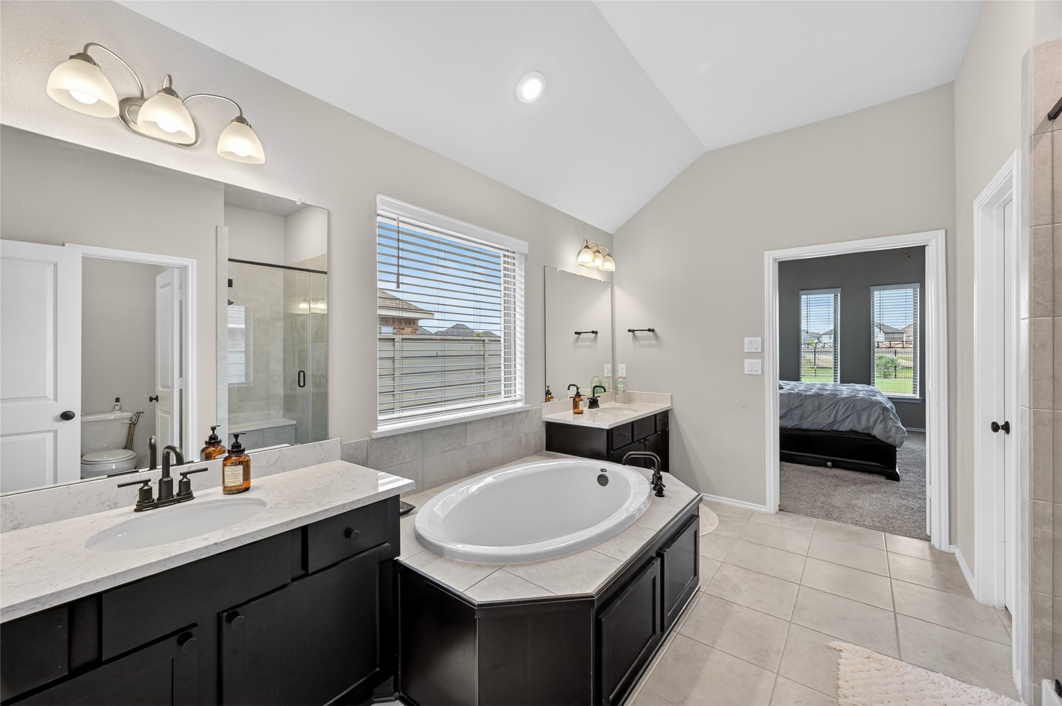 4731 Cedar Butte Lane Manvel, TX 77578 - Photo 23 of 42 a en suite bathroom with a sink double vanity granite tub shower and a mirror