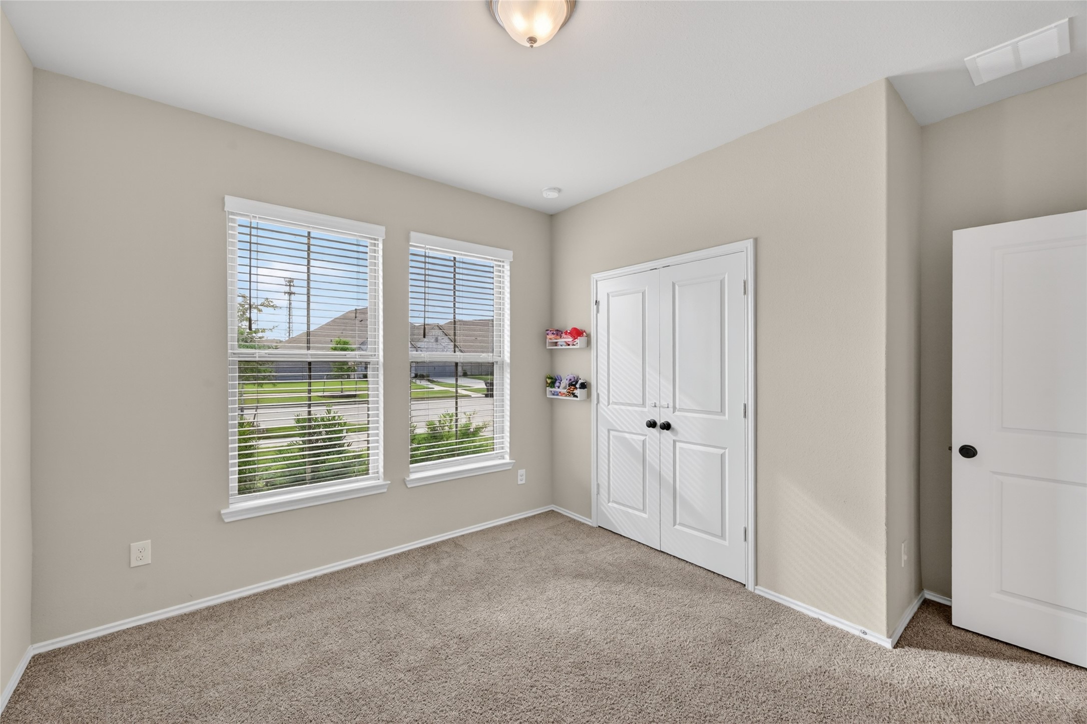 4731 Cedar Butte Lane Manvel, TX 77578 - Photo 26 of 42 a view of an empty room with a window and closet area