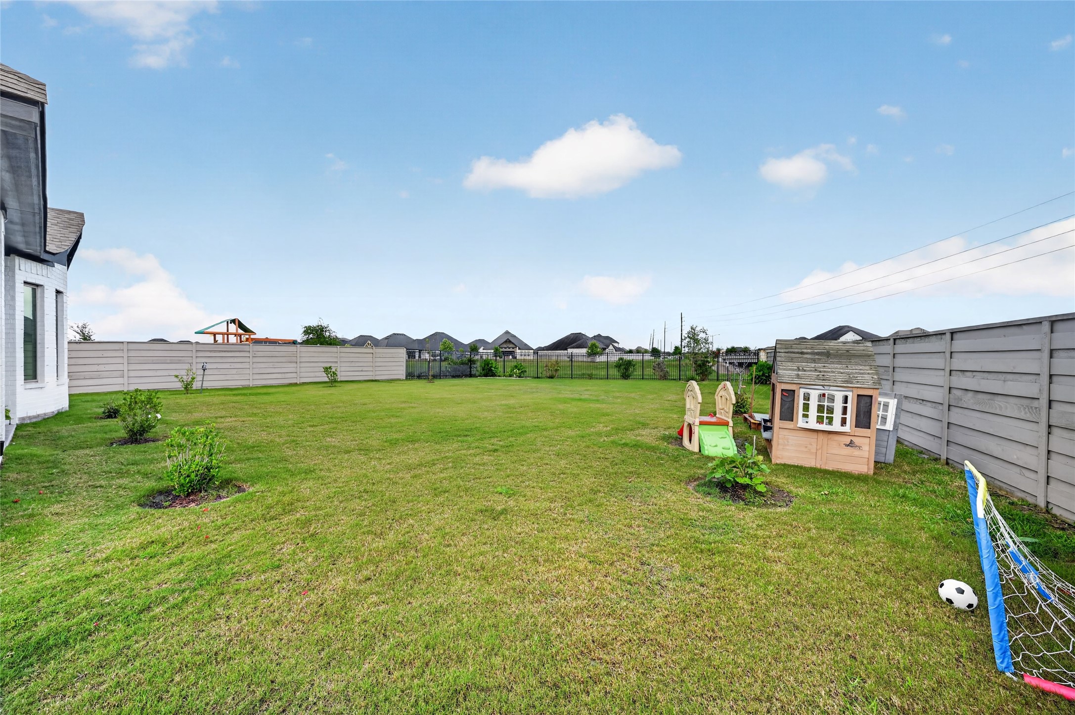 4731 Cedar Butte Lane Manvel, TX 77578 - Photo 40 of 42 a view of a garden with a building in the background