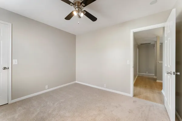 an empty room with a empty space and chandelier fan