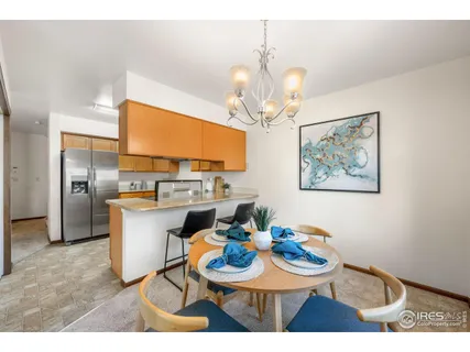 a view of a dining room with furniture a chandelier and wooden floor