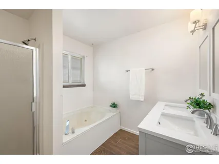 a bathroom with a bathtub sink and mirror