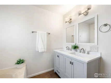a bathroom with a sink vanity and mirror