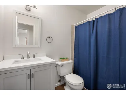 a bathroom with a toilet a sink a vanity and mirror