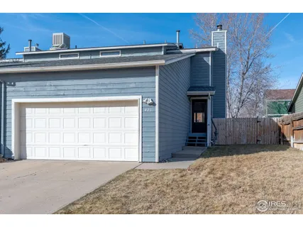 a view of an empty room with a fireplace and wooden cabinets