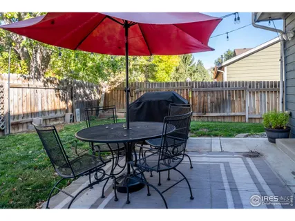 a view of backyard with outdoor seating and wooden floor