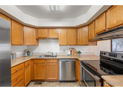 a kitchen with a sink a stove and cabinets