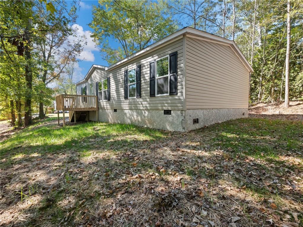4945 Scott Road Cumming, GA 30041 - Photo 1 of 1 a view of a house with yard and a tree