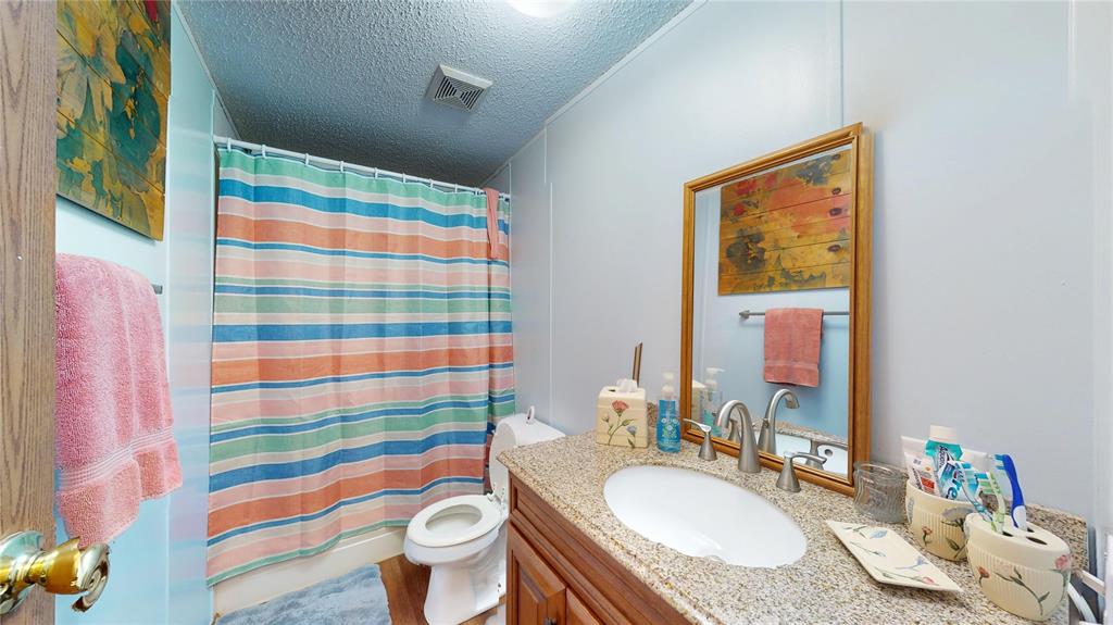 670 Arbin Culpepper Road Jonesboro, LA 71251 - Photo 8 of 17 a bathroom with a sink toilet and shower curtain