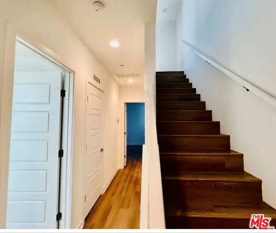 a view of entryway and hall with wooden floor