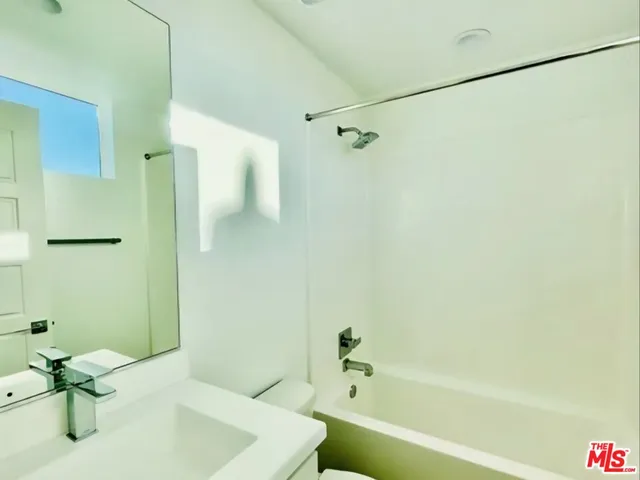 a bathroom with a tub and a shower