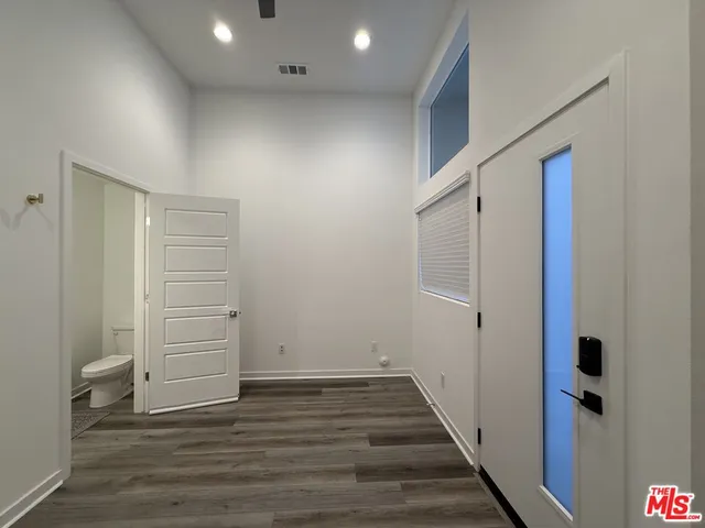 a view of a hallway with wooden floor and entryway