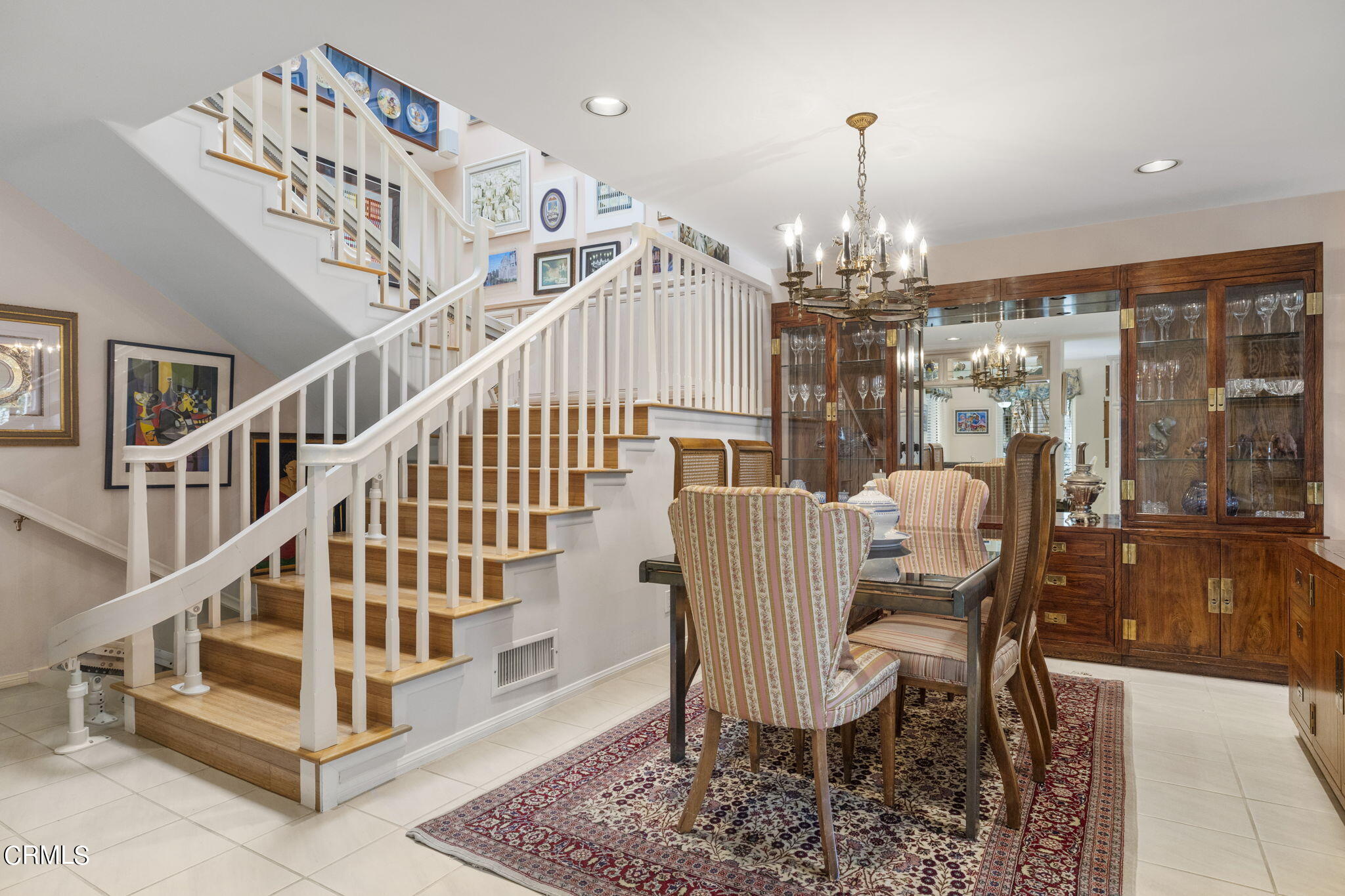 2226 Cannes Square Oxnard, CA 93035 - Photo 12 of 75 a view of a dining room with stairs wooden floor and a chandelier