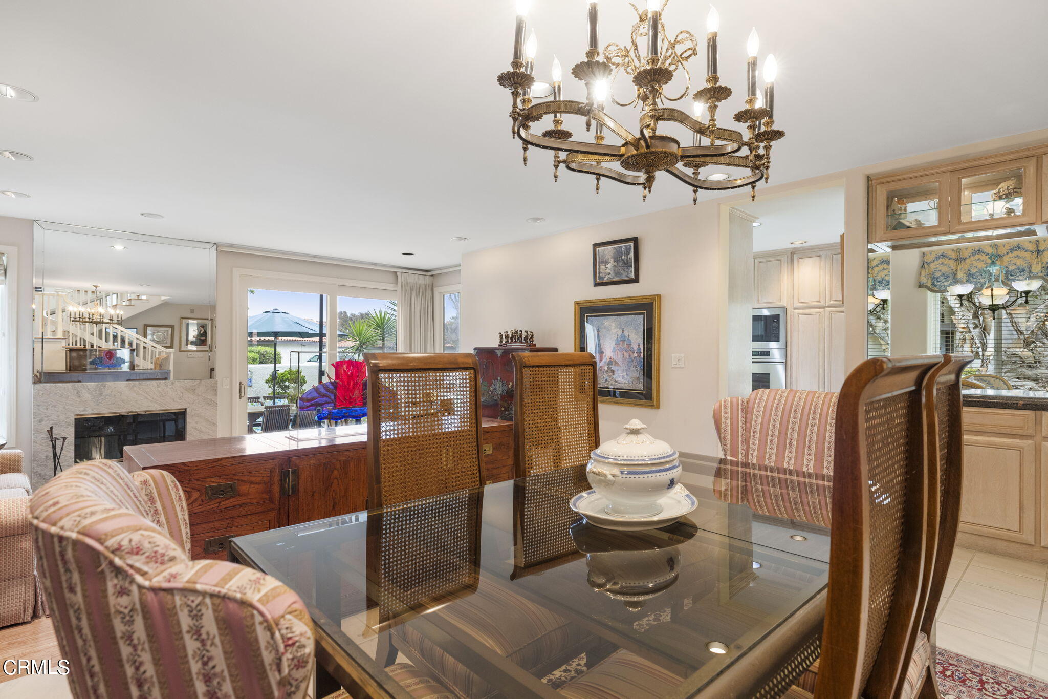 2226 Cannes Square Oxnard, CA 93035 - Photo 14 of 75 a living room with furniture a chandelier and a dining table