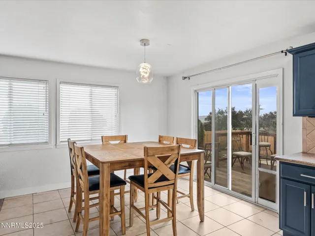 a view of a dining room with furniture large windows and wooden floor