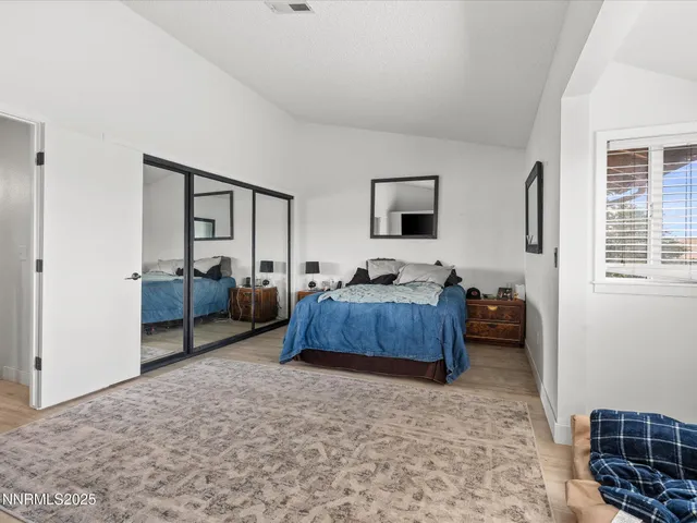 a bedroom with furniture and a window