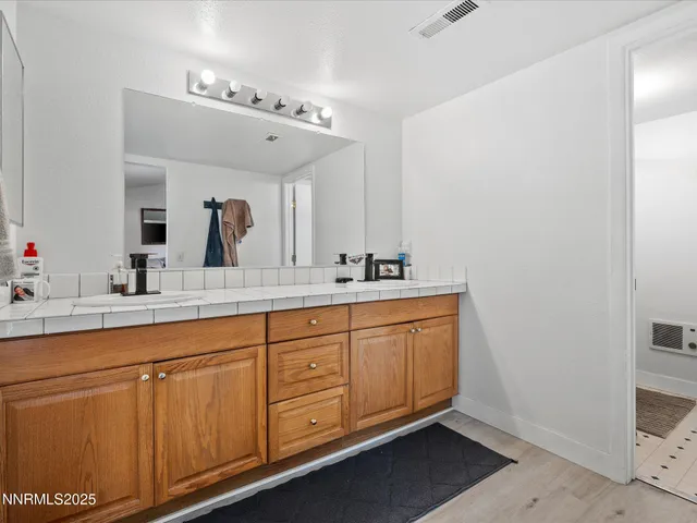 a spacious bathroom with a double vanity sink and a mirror