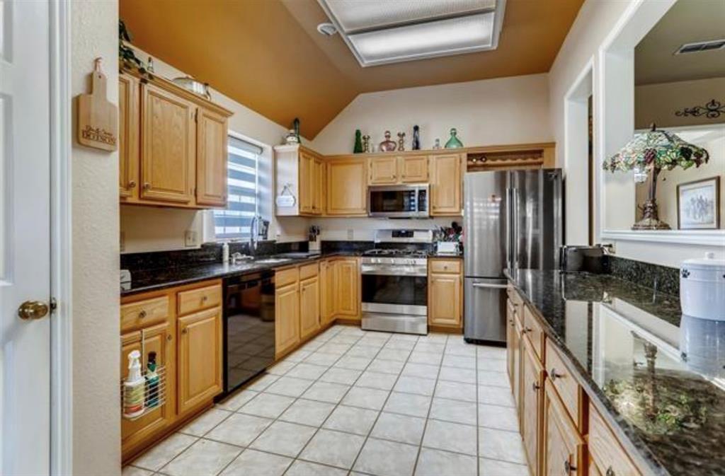 1924 Sunset Path Lewisville, TX 75067 - Photo 13 of 37 a kitchen with stainless steel appliances granite countertop a refrigerator and a stove top oven