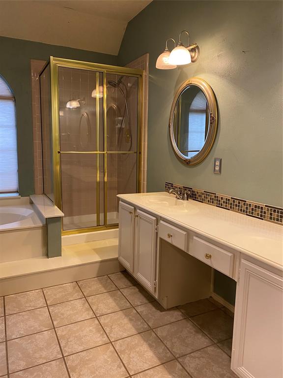 1924 Sunset Path Lewisville, TX 75067 - Photo 20 of 37 a bathroom with a sink mirror vanity and bathtub