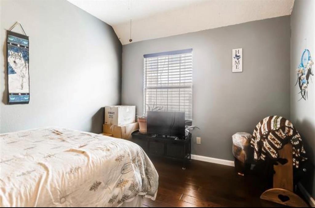 1924 Sunset Path Lewisville, TX 75067 - Photo 24 of 37 a bedroom with a bed and a chandelier