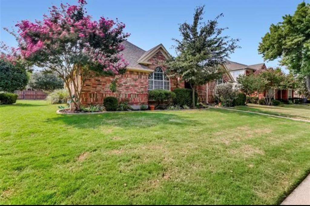 1924 Sunset Path Lewisville, TX 75067 - Photo 4 of 37 a front view of a house with garden