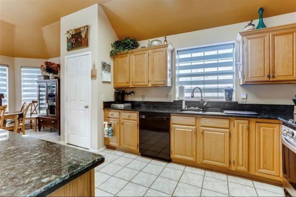 1924 Sunset Path Lewisville, TX 75067 - Photo 10 of 37 a kitchen with stainless steel appliances granite countertop a stove a sink and a refrigerator